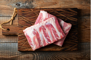 Raw pork ribs with spices, salt and, a Food & Drink Photo by Budarinphoto