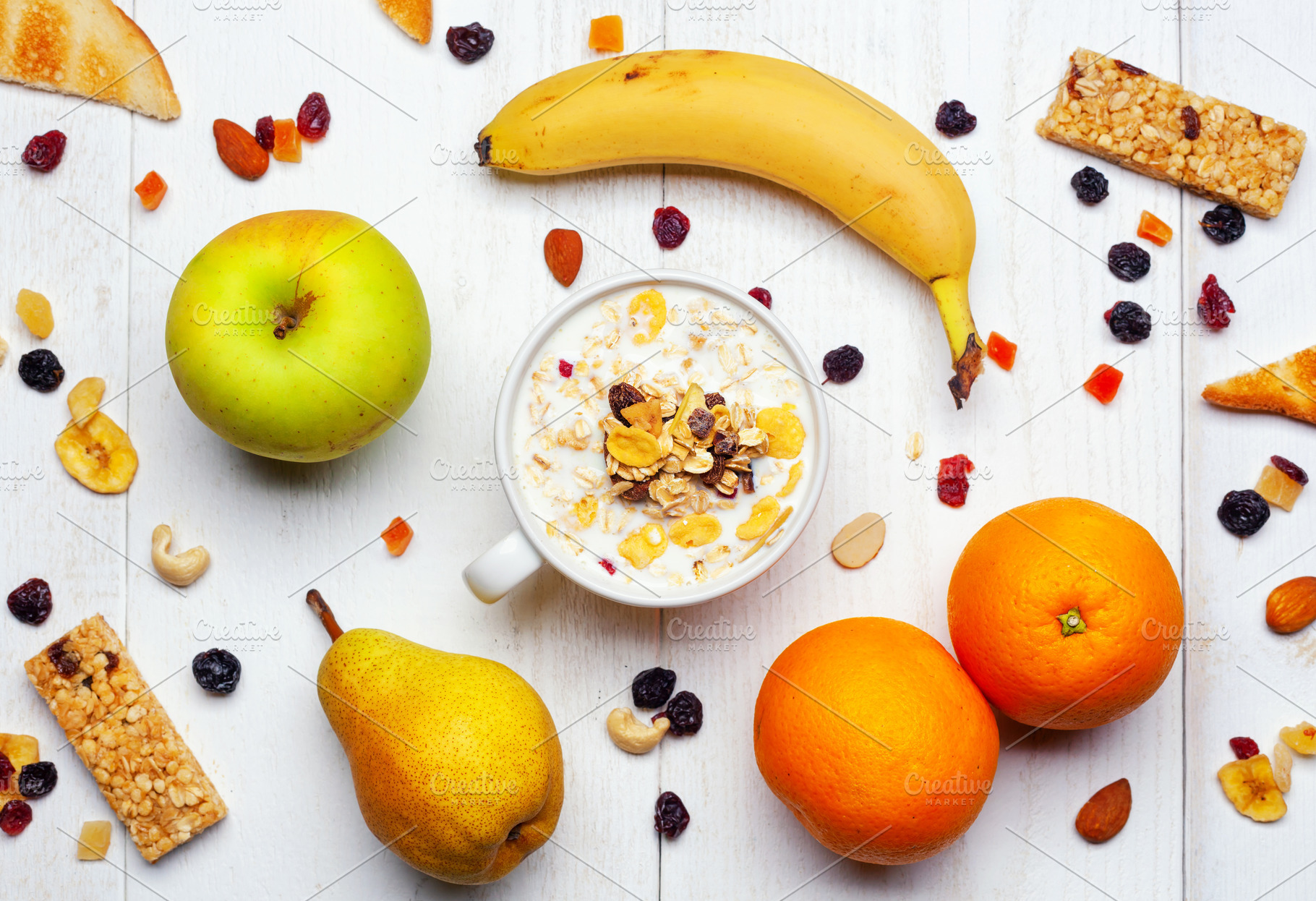 Healthy breakfast with milk, cereals, fruits and energy bars on white wooden ta, a Food & Drink Photo by Antonio Gravante Market