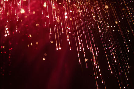 A close-up view of shimmering red lights resembling falling sparks or raindrops, an Arts & Entertainment Photo by Textures & Backgrounds