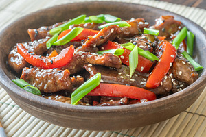 Chinese Beef Stir Fry With Red Peppers On Bamboo Mat Bright Pres, a Food & Drink Photo by Alexander Prokopenko