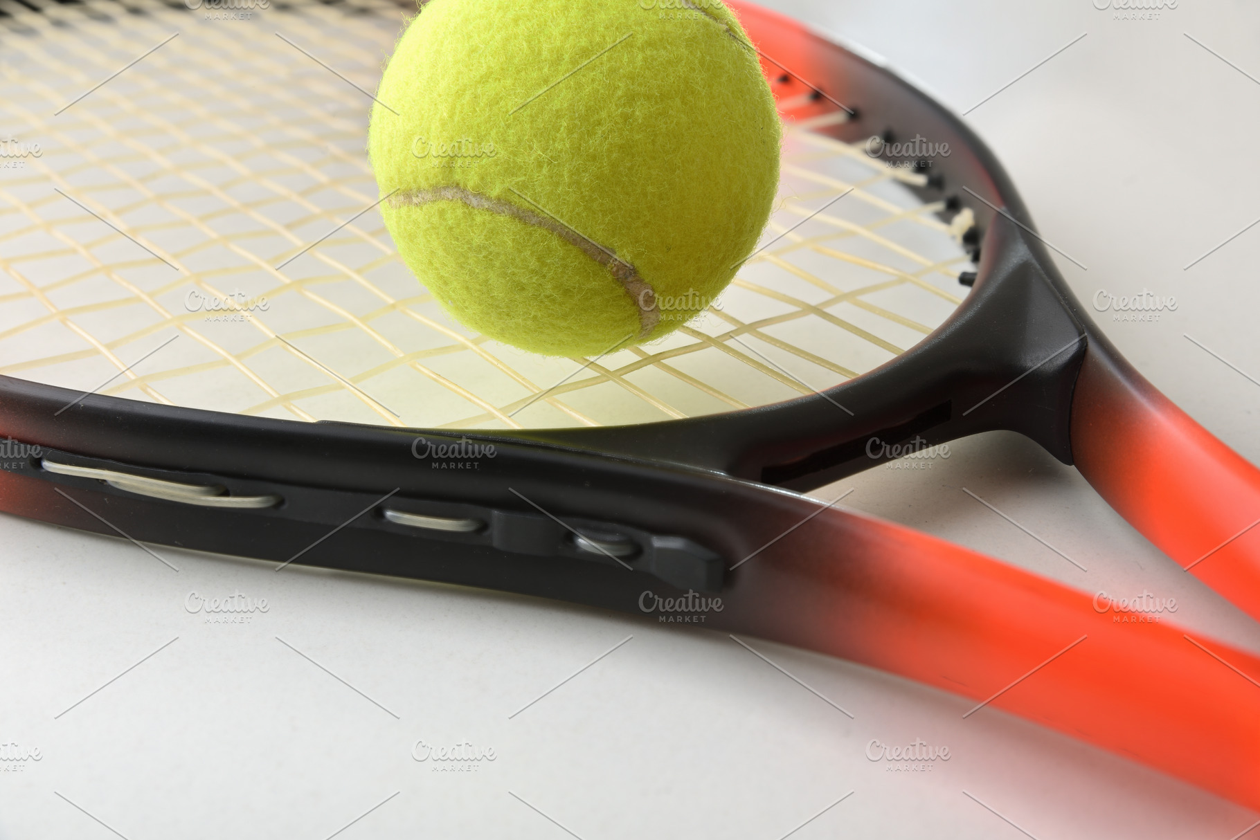 Tennis Ball Resting on Racket Strings, a Sports & Recreation Photo by Davizro's Market