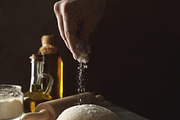 Man sprinkle flour on dough against dark background, a Food & Drink Photo by AtlasStudio PRO (Thumbnail 3 of 4)