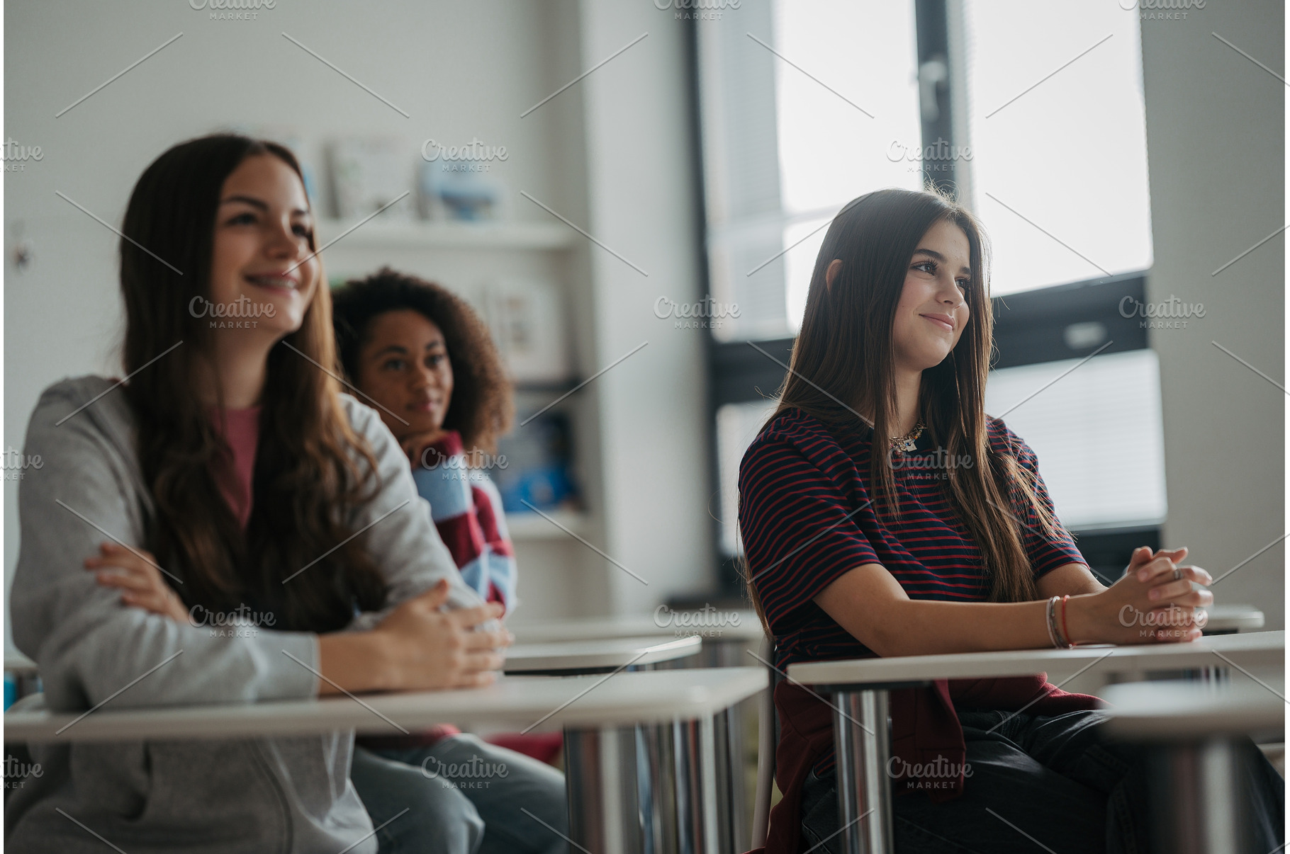 Confident teen student standing in, a School & Education Photo by HalfPoint