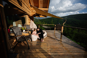 Mother and child bonding on a wooden terrace in a serene forest setting, a Photo by AS photostudio