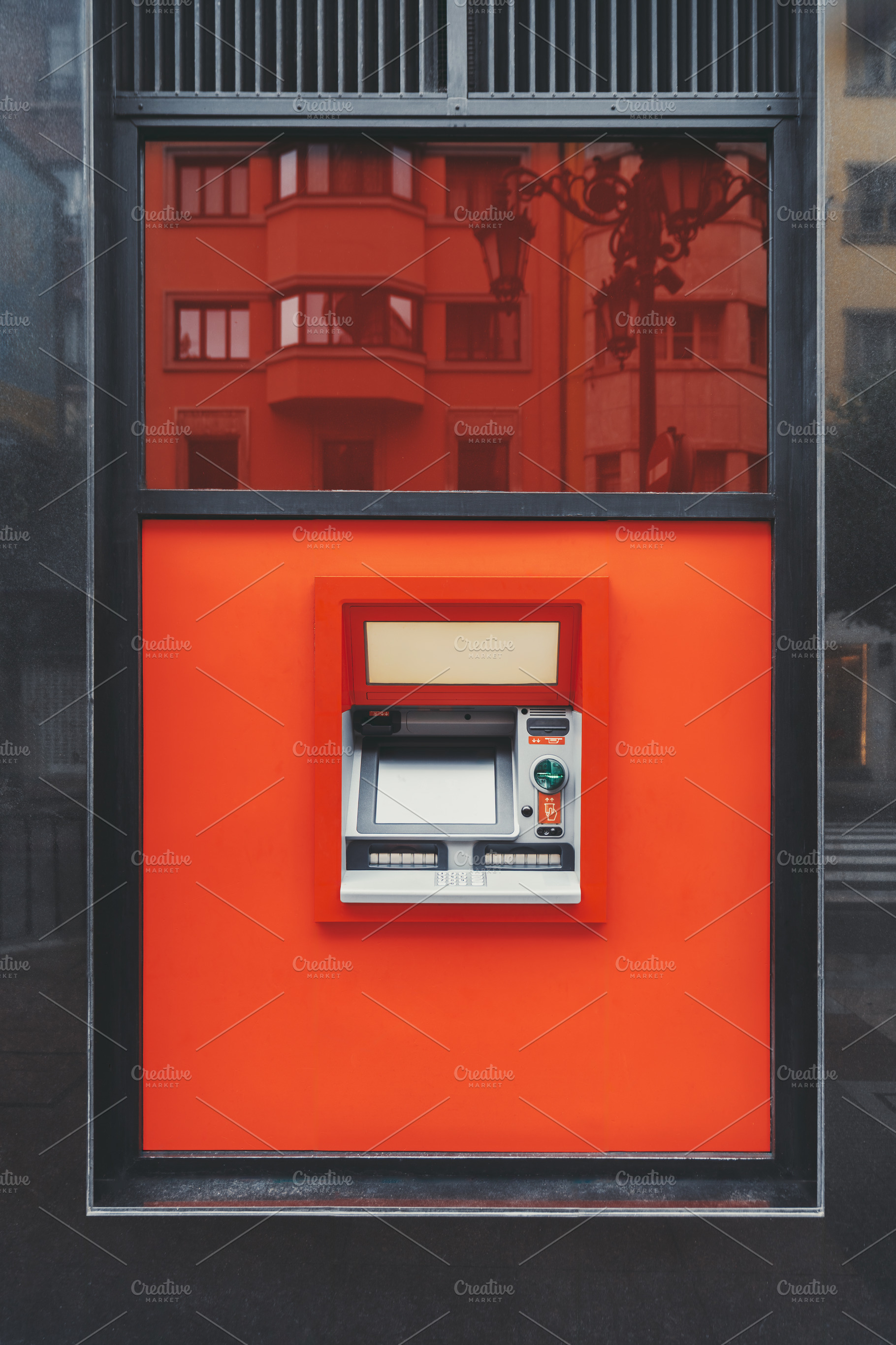ATM in red urban wall reflection, a Business Photo by SkyNext