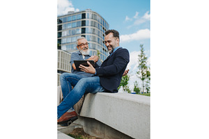 Father and adult son sharing a, a Person Photo by HalfPoint