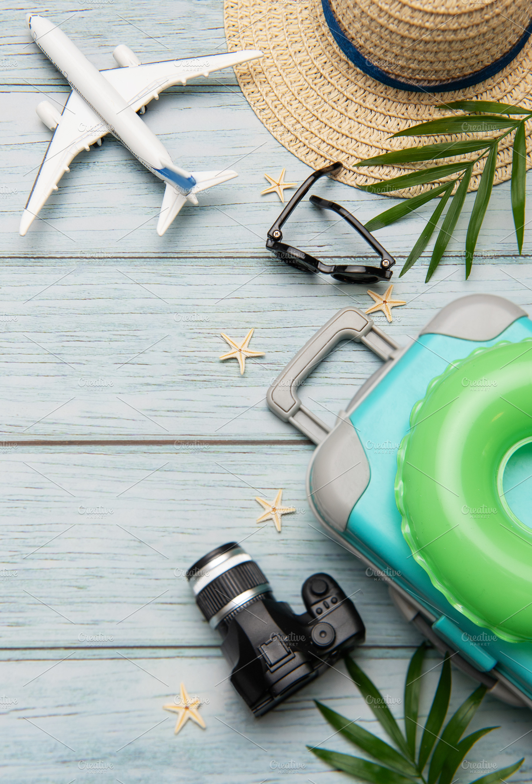Travel accessories lying on wooden background for summer vacatio, a Holiday Photo by Olena Rudo