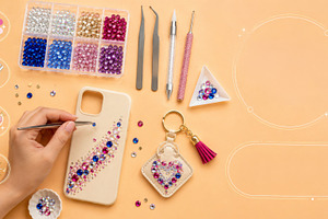 Hands decorating rhinestone phone ca, a Photo by Dvoevnore photos