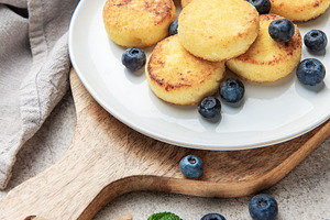 Syrniki pancakes with blueberries and mint for breakfast, a Food & Drink Photo by Olena Rudo