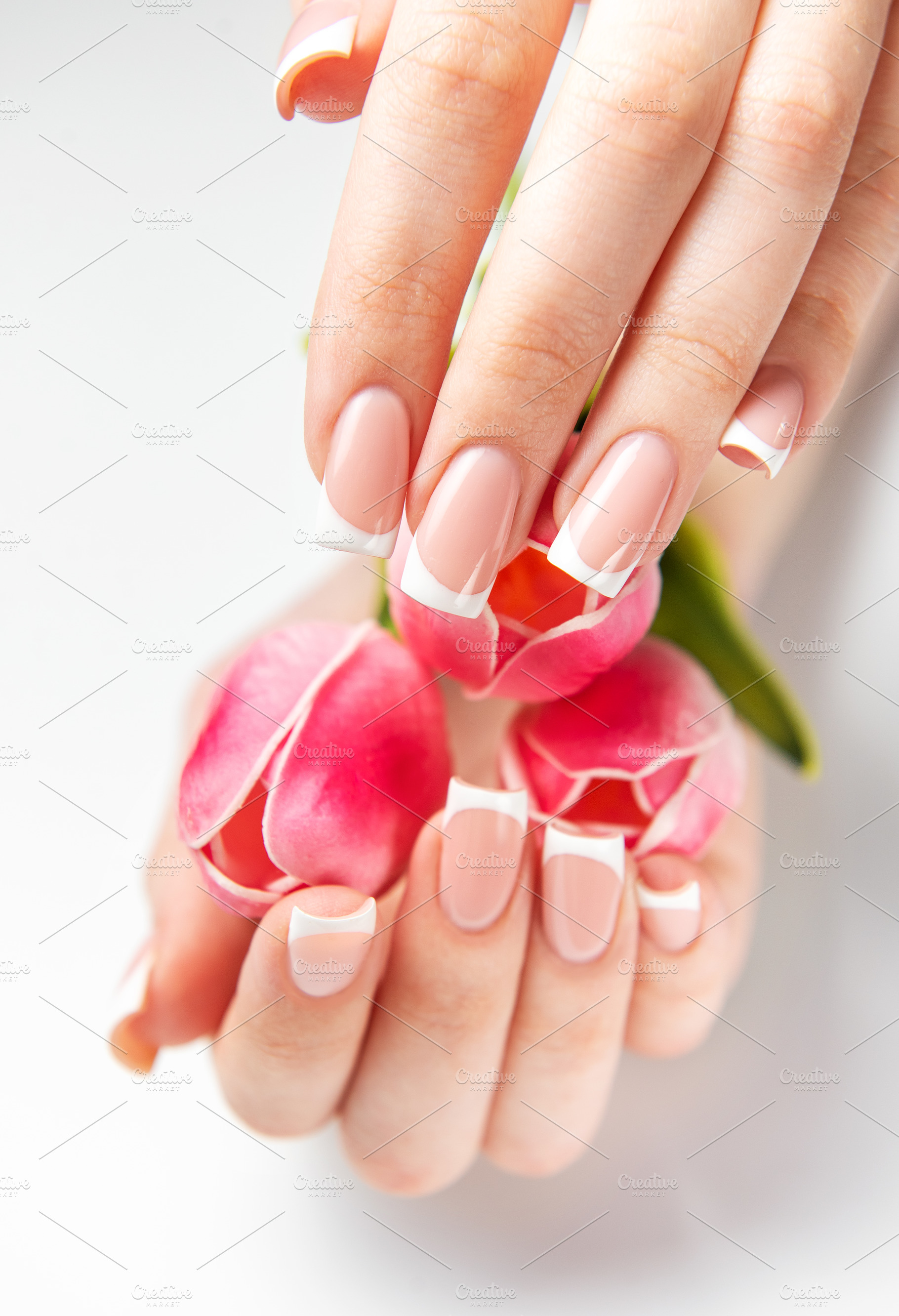 Woman showing french manicure holding pink tulips, a Beauty & Fashion Photo by Olena Rudo
