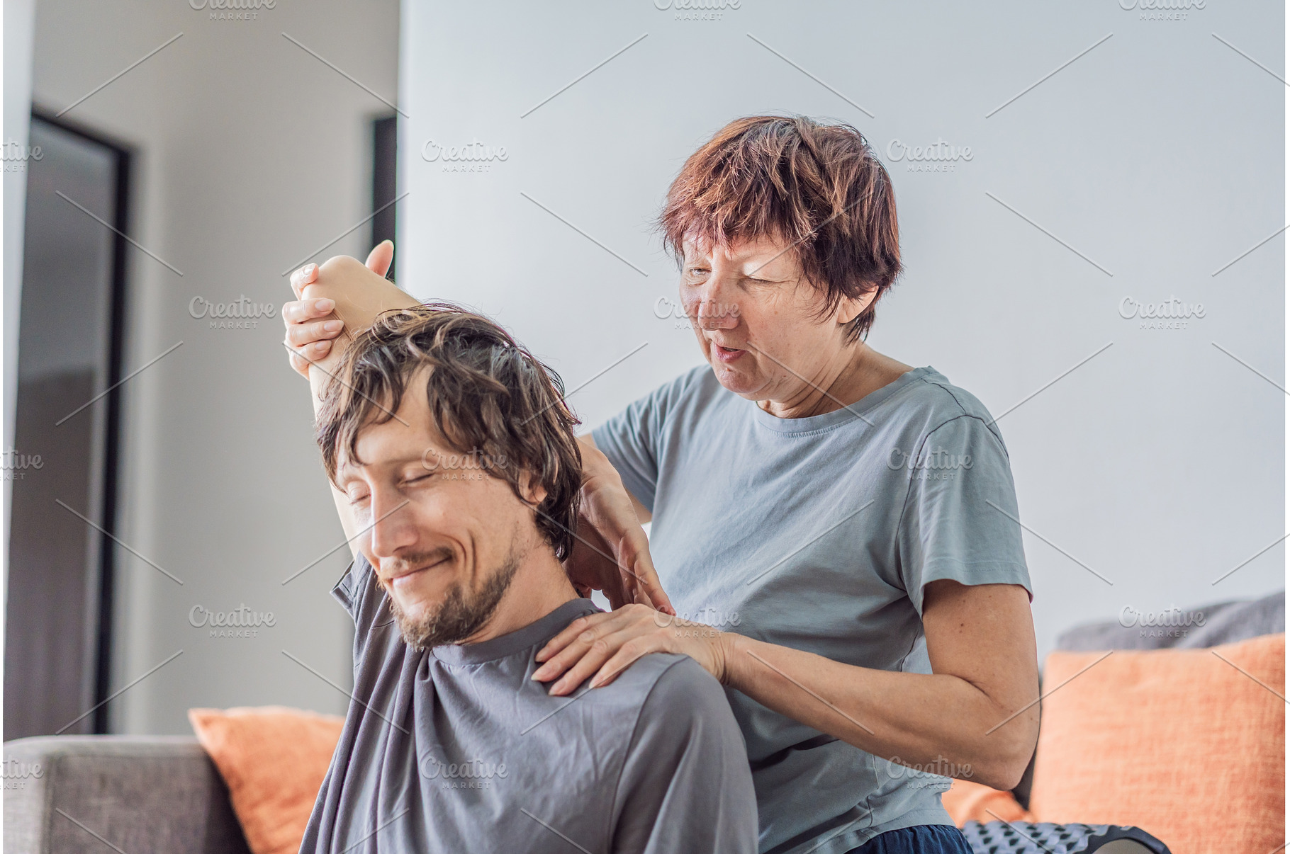 Older woman giving her adult son a, a Person Photo by Elizaveta Galitskaya