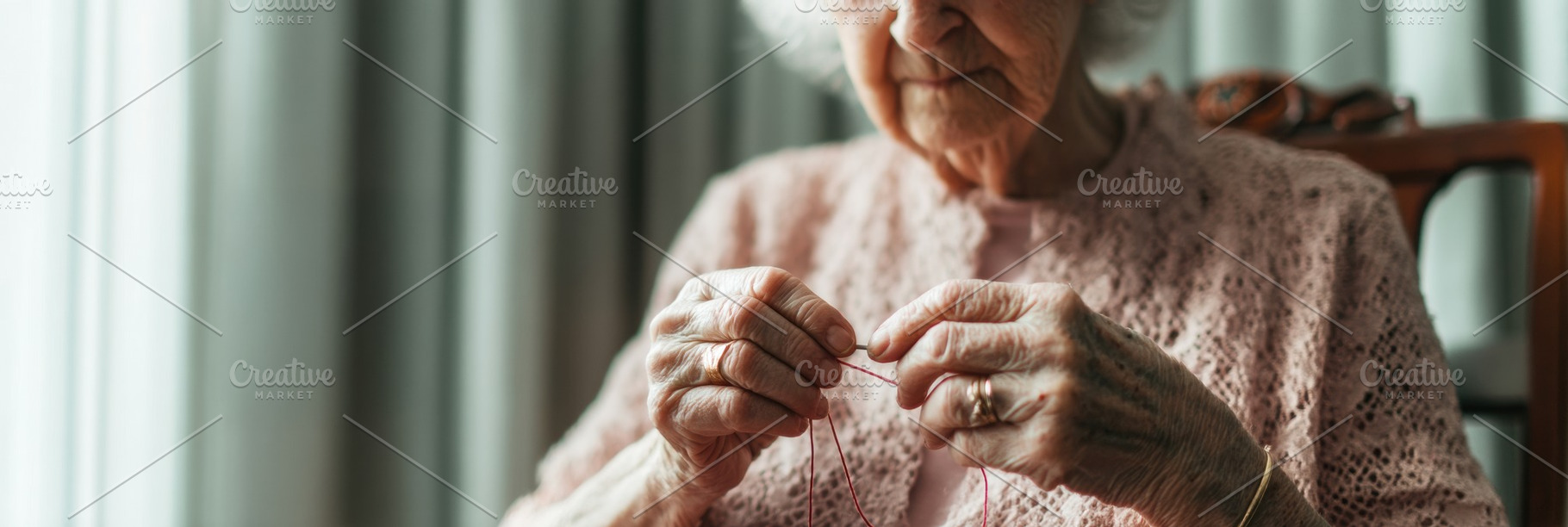 Elderly woman threading needle, a Person Photo by Virgo Studio