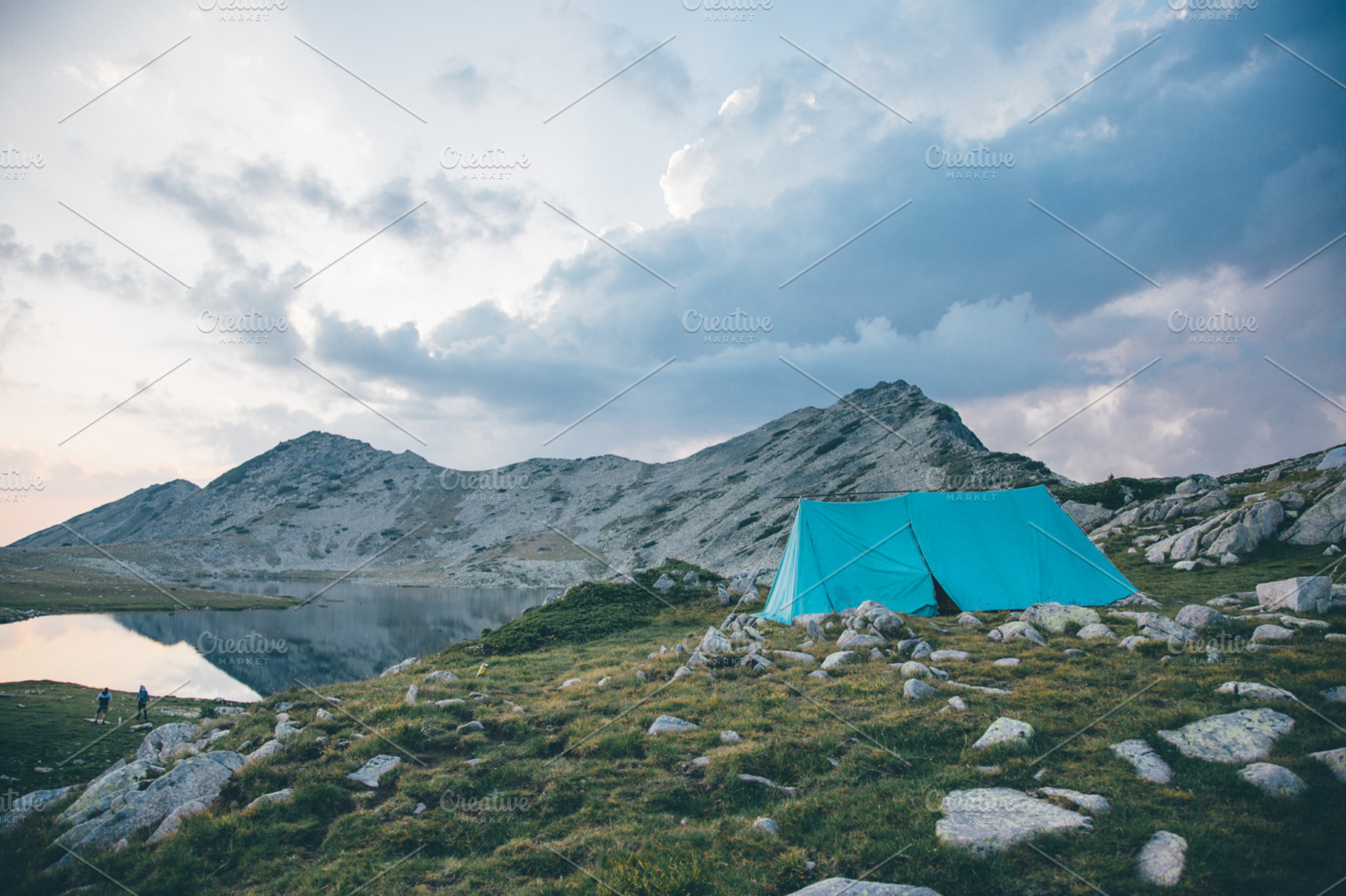 Tent near a lake in a mountian, a Nature Photo by Mukuko Studio