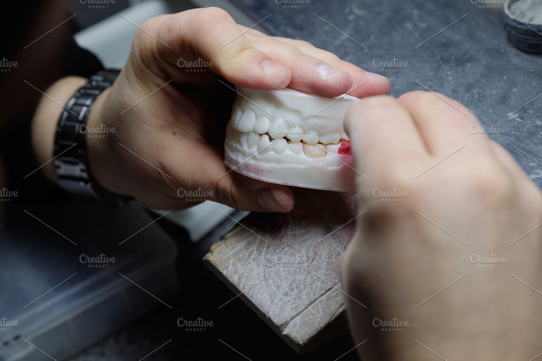 Close-up of a specialist performing accurate grinding on a high-tech dental moc, a Health & Medical Photo by Rohan Photography