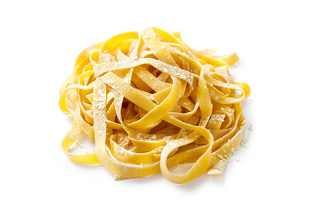 Raw fettuccine pasta forming a pile, a Food & Drink Photo by Ylivdesign