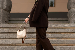 Young woman walking down stone steps, a Person Photo by Elena Vagengeim