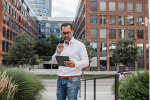 Businessman in front of office, a Person Photo by HalfPoint