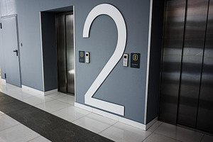 Modern elevator lobby with level two number displayed on a clean wall, a Photo by AS photostudio