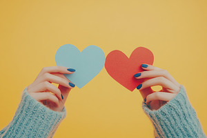 Woman holds in hands love hearts, a Holiday Photo by AlyaAnd
