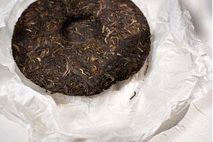Puer tea cake displayed on white, a Background Photo by darksoul72