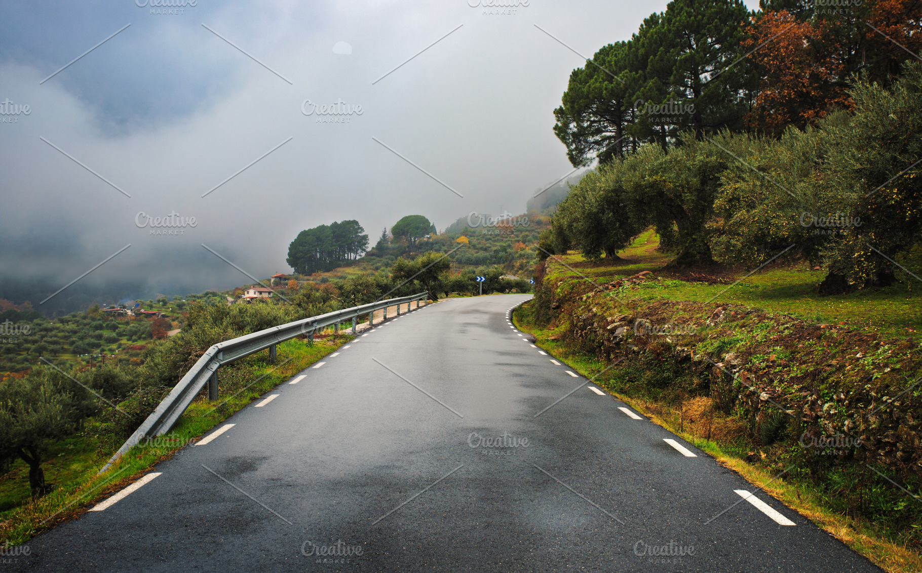 Rural paved road between green hills, a Transportation Photo by Perpis