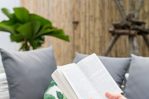 A woman holding a reading a novel