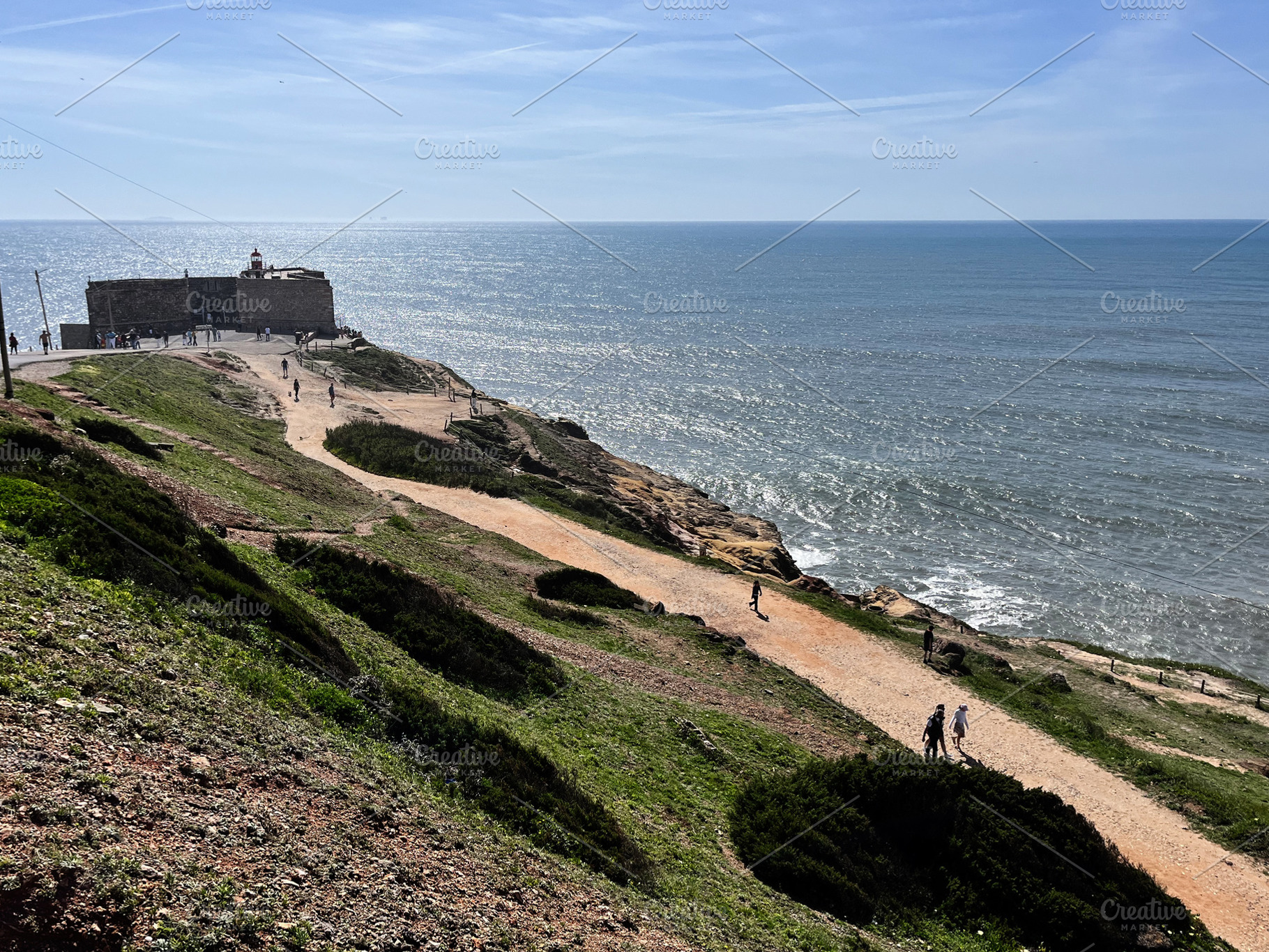 Cliffside walkway near a lighthouse overlooking the ocean in Nazare, Portugal, a Photo by AS photostudio