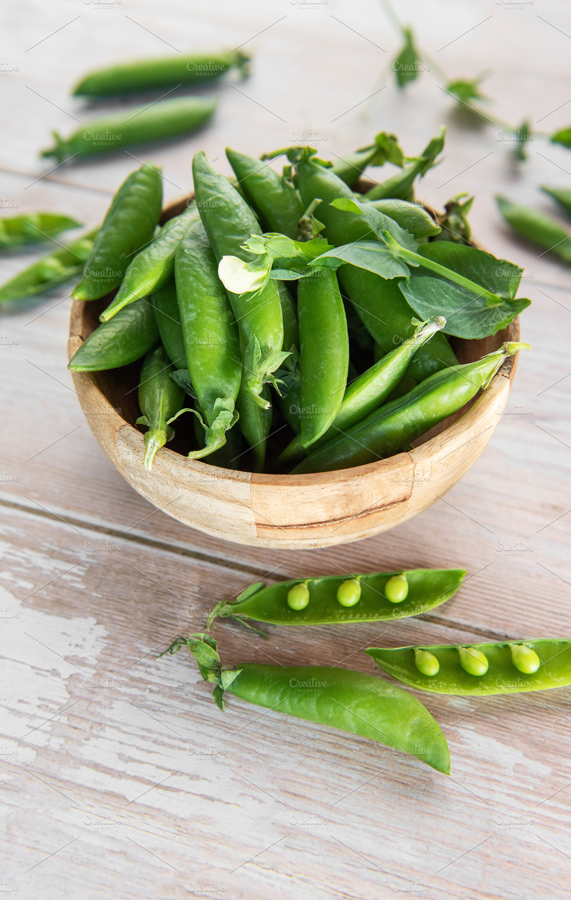 Fresh green pea pods in wooden bowl, a Food & Drink Photo by Olena Rudo