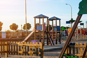 Public kids playground in Spain made of wood and plastic