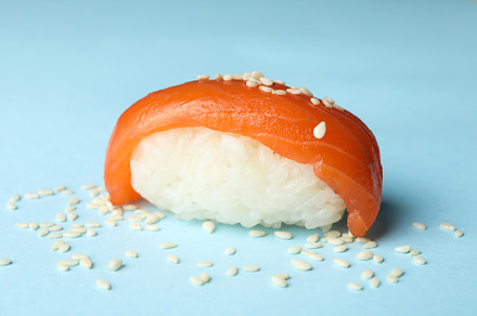 Sushi roll on blue background, close up. Japanese food, a Food & Drink Photo by AtlasStudio