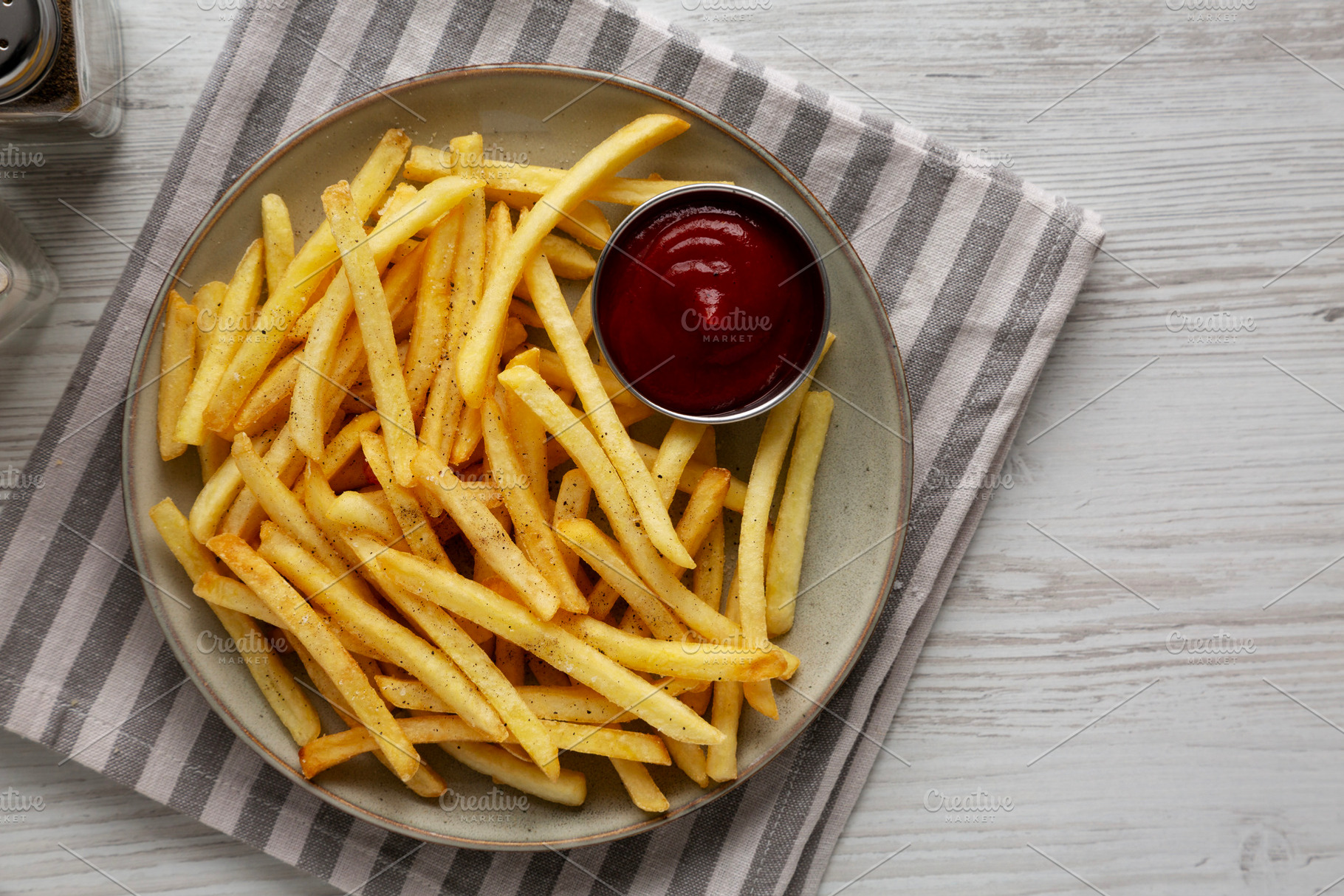 Homemade French Fries and Ketchup on a Plate, top view. Space fo, a Food & Drink Photo by LiudmylaChuhunova