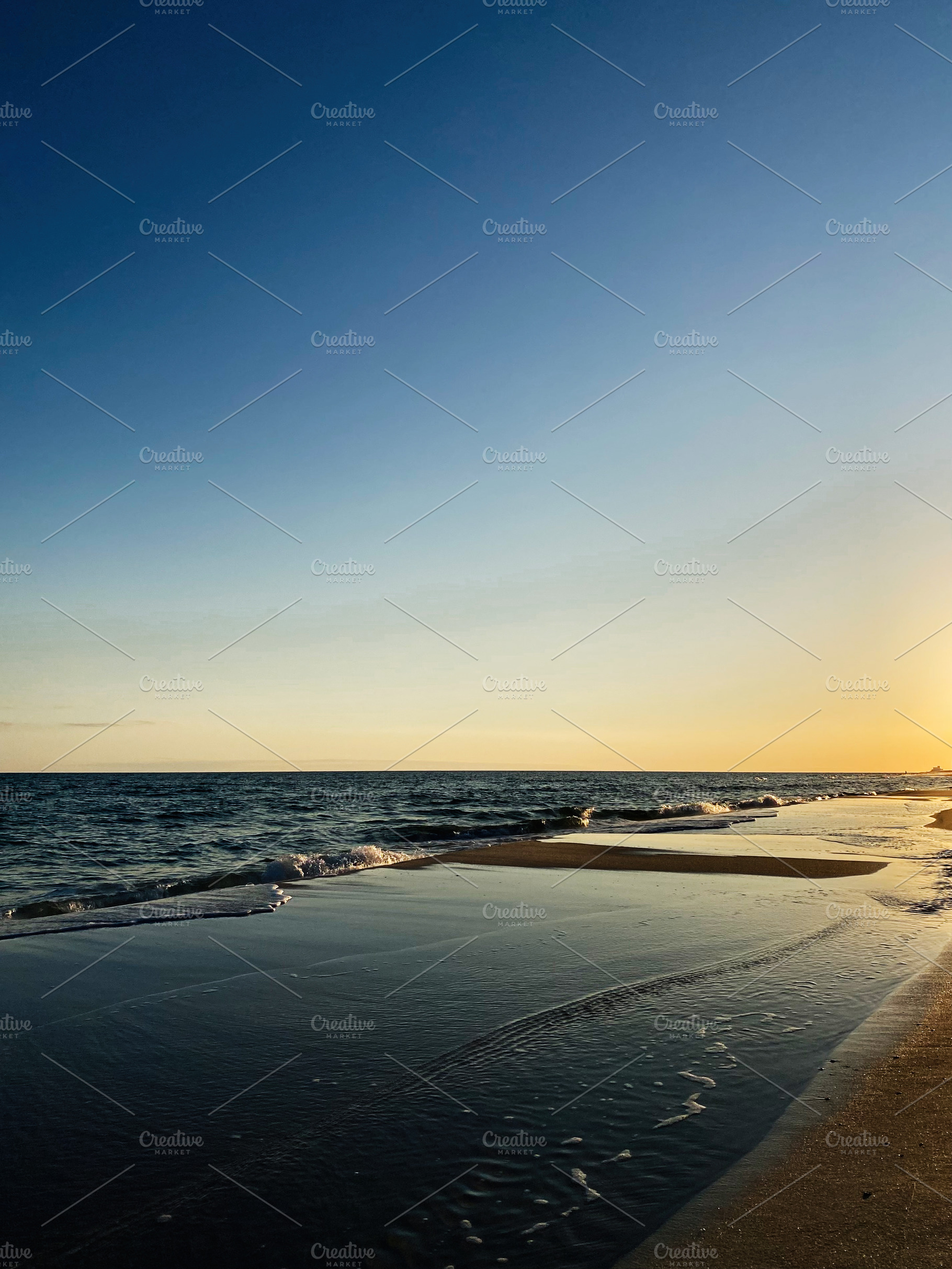 Sunset over a calm Florida Pensacola beach with gentle waves and golden light, a Nature Photo by AS photostudio