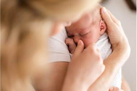Unrecognizable mother holding her, a Person Photo by HalfPoint