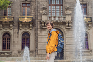 Male tourist standing near, an Architecture Photo by Elizaveta Galitskaya