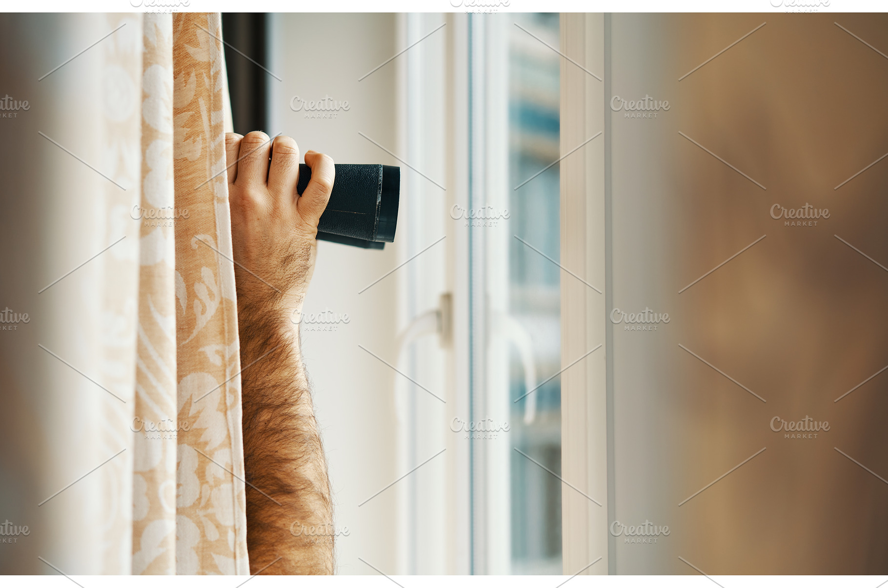 Arm holding binoculars peeking, a Person Photo by Gladkov photography