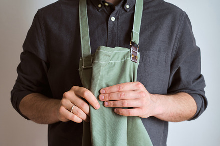 A man in a kitchen apron. Chef work, a Person Photo by Iuliia Pilipeichenko