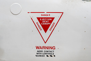 Ejection seat warning sign on the fuselage of an old aircraft, a Transportation Photo by GoodGoods