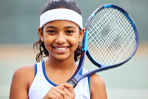 Smiling girl holding tennis racket, a Sports & Recreation Photo by DanFLCreativo