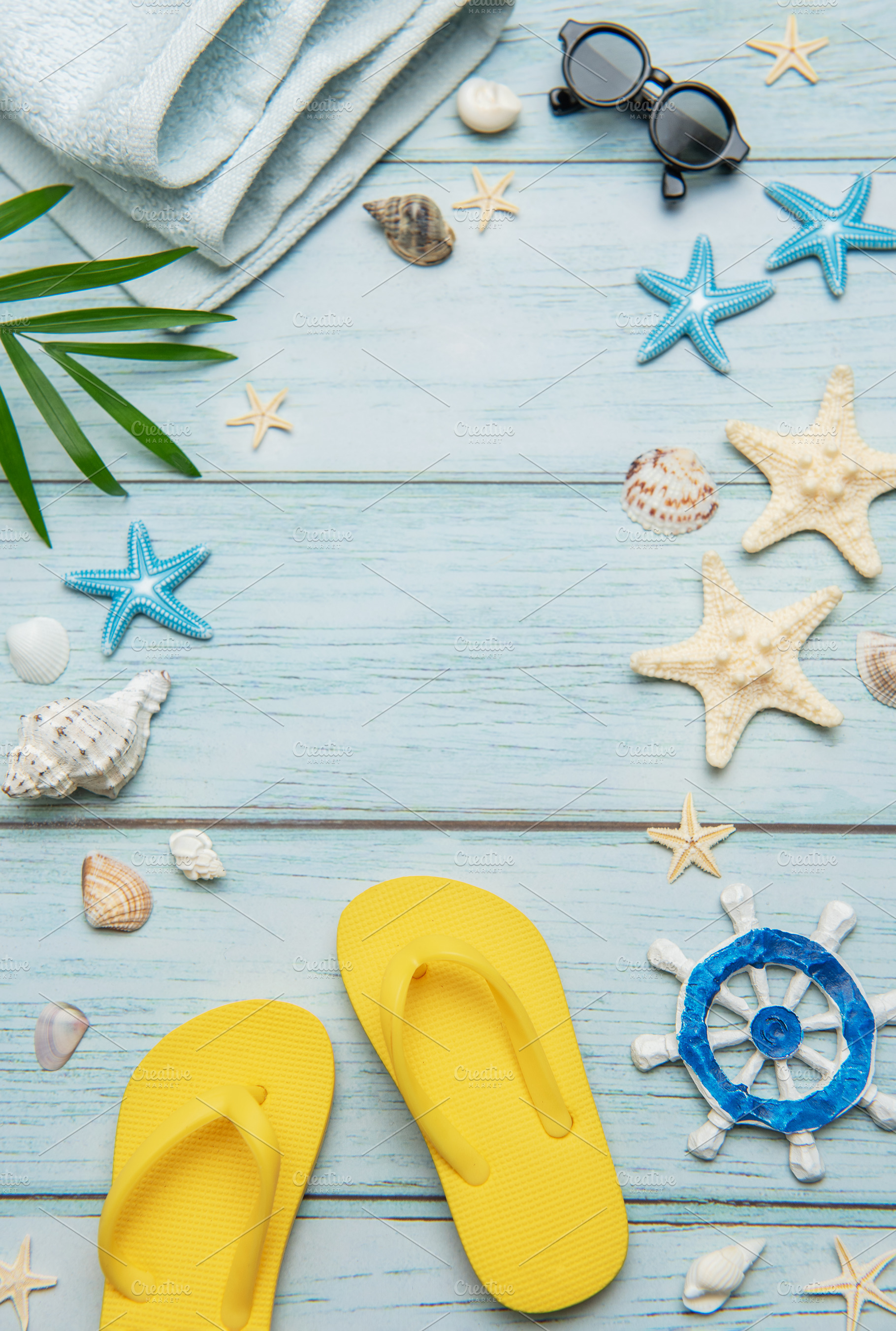 Summer essentials creating a frame on a light blue wooden backgr, a Holiday Photo by Olena Rudo