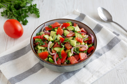 Homemade Mediterranean Cucumber Tomato Salad in a Bowl, side vie, a Food & Drink Photo by LiudmylaChuhunova