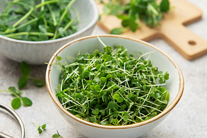 Fresh green microgreens in bowls for healthy eating, a Photo by Olena Rudo