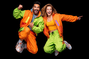 Couple celebrates joyfully in vibrant sportswear during an energetic dance perf, a Photo by AlyaAnd