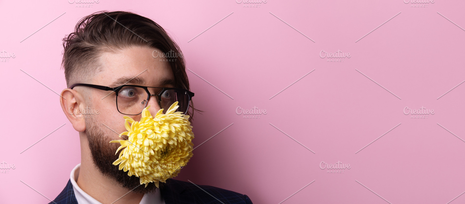 Portrait of a man with glasses wearing a yellow flower mask agai, a Person Photo by Ales Munt
