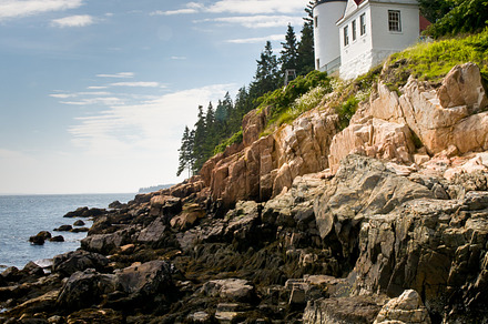 Bass harbor head lighthouse featuring light house, cliff, and sky