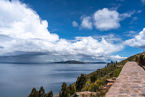 Stone path overlooking nature and terraces on Taquile Island, La, a Nature Photo by GoodGoods