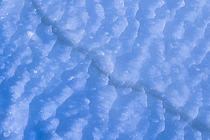 Abstract blue ice texture with snow, winter background, a Photo by MDBildes