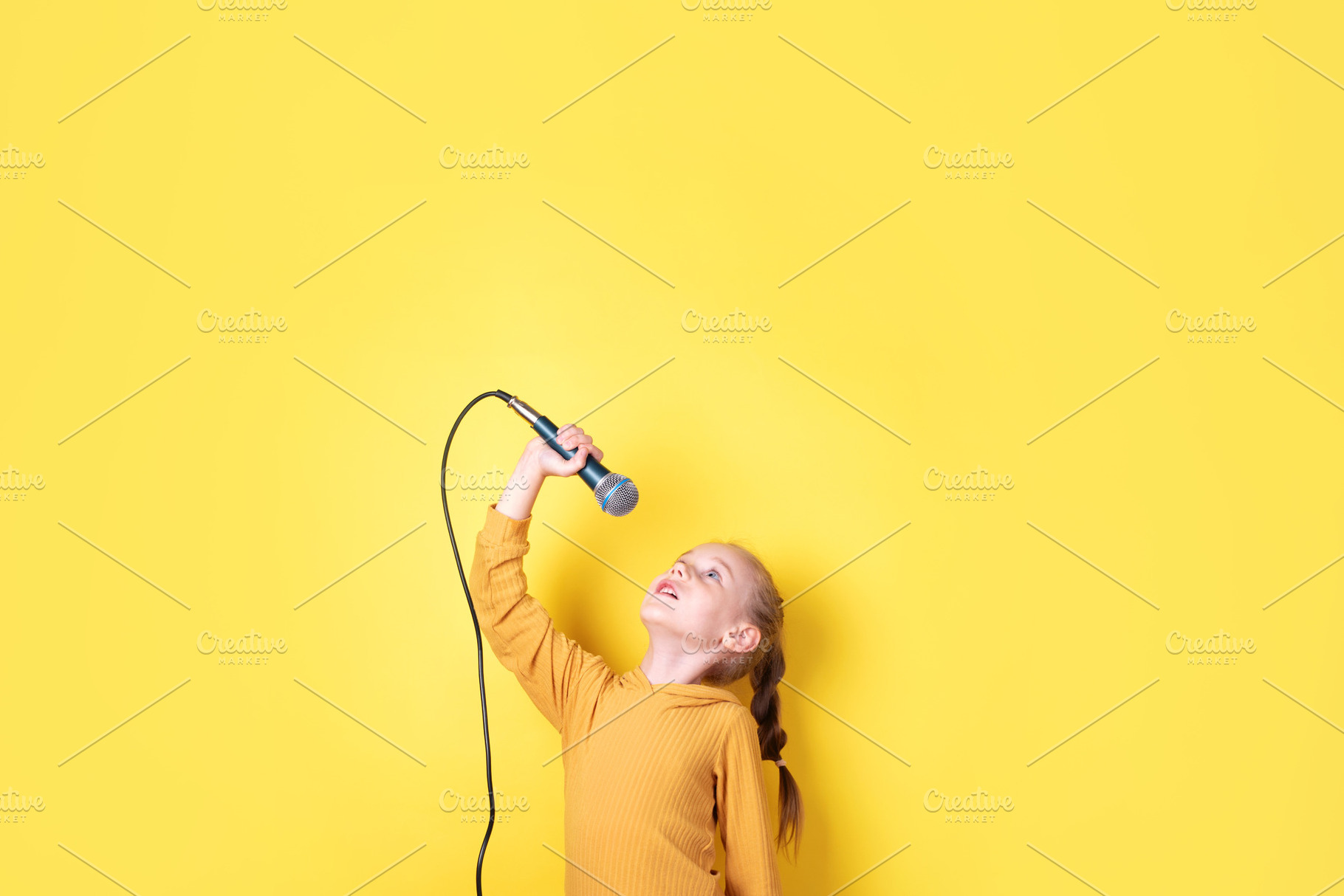 Happy Girl Singing with Microphone, a Person Photo by Ales Munt