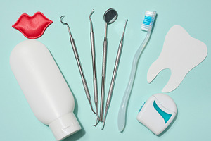 Red decorative lips, white tube of toothpaste, dental floss in w, a Health & Medical Photo by ndanko