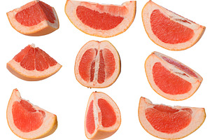 Various slices of juicy grapefruit on an isolated background, a Food & Drink Photo by ndanko