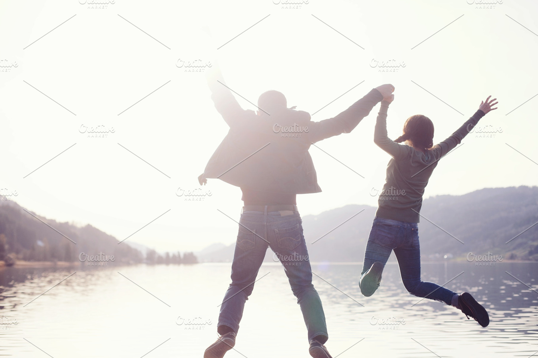 Couple jumping in lake